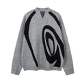 Oversized grey knit sweater with large black abstract swirl jacquard pattern on front, streetwear pullover