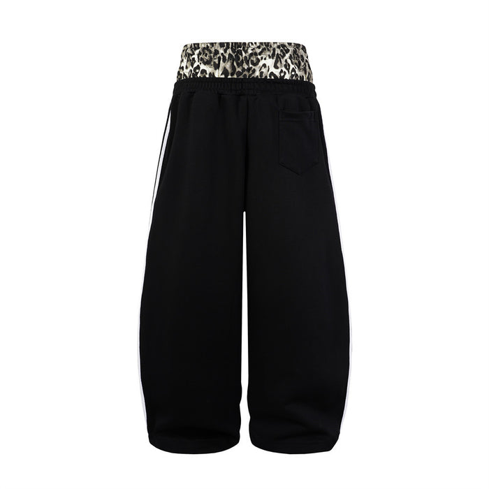 Back view of black wide-leg sweatpants with leopard-print waistband, white side stripes and rear pocket