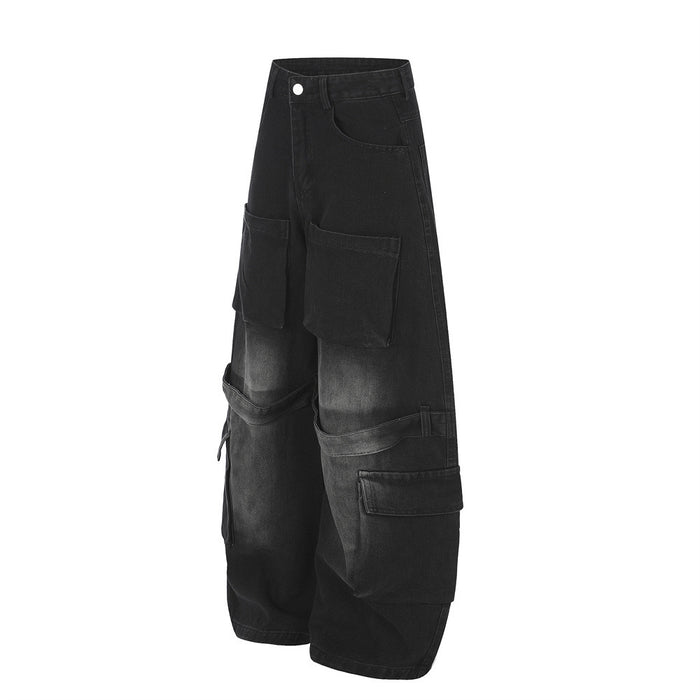 Side view of black wide-leg cargo jeans showing layered thigh and lower-leg utility pockets