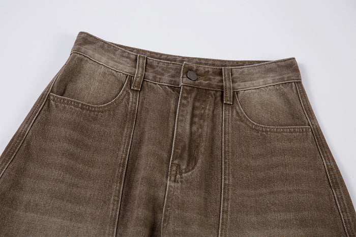 Front waistband close-up showing the button closure, zipper fly, belt loops, and curved hand pockets
