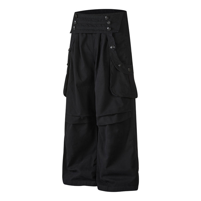 Angled front view of black wide-leg cargo trousers showing layered cargo pockets and button details