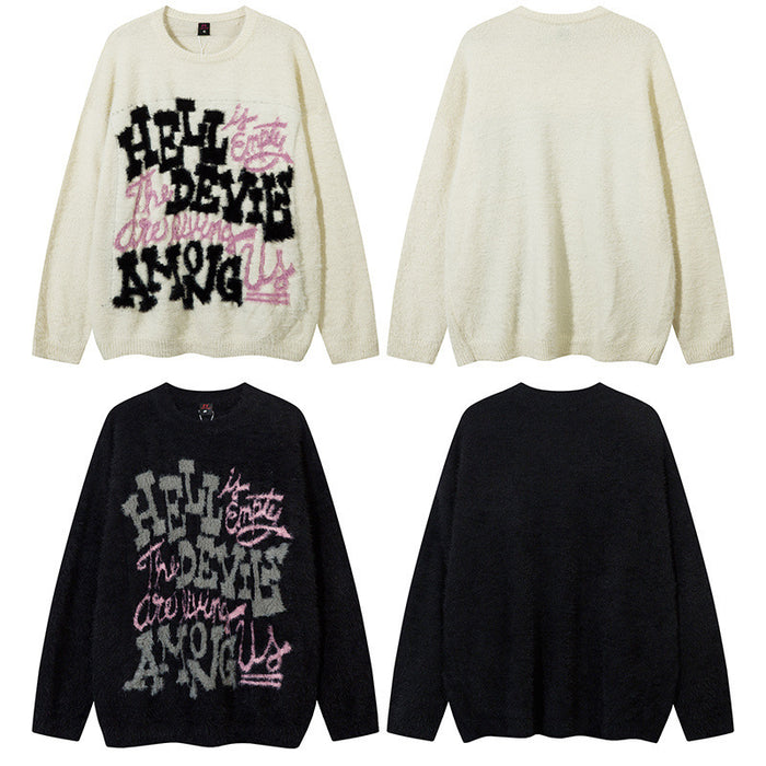 Cream and black oversized knit sweaters shown in front and back views with contrasting fuzzy graphic lettering