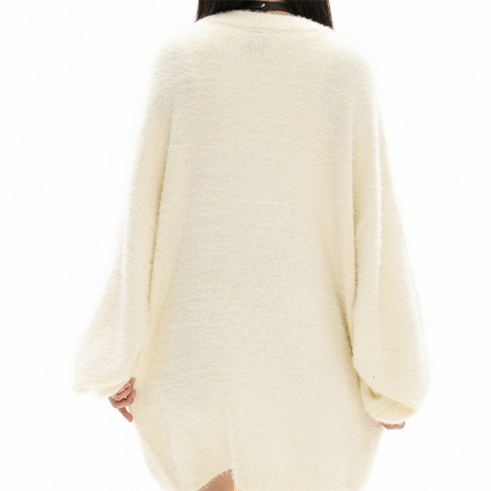 Back view of a cream oversized knit sweater worn on a model, showing its plain fuzzy texture
