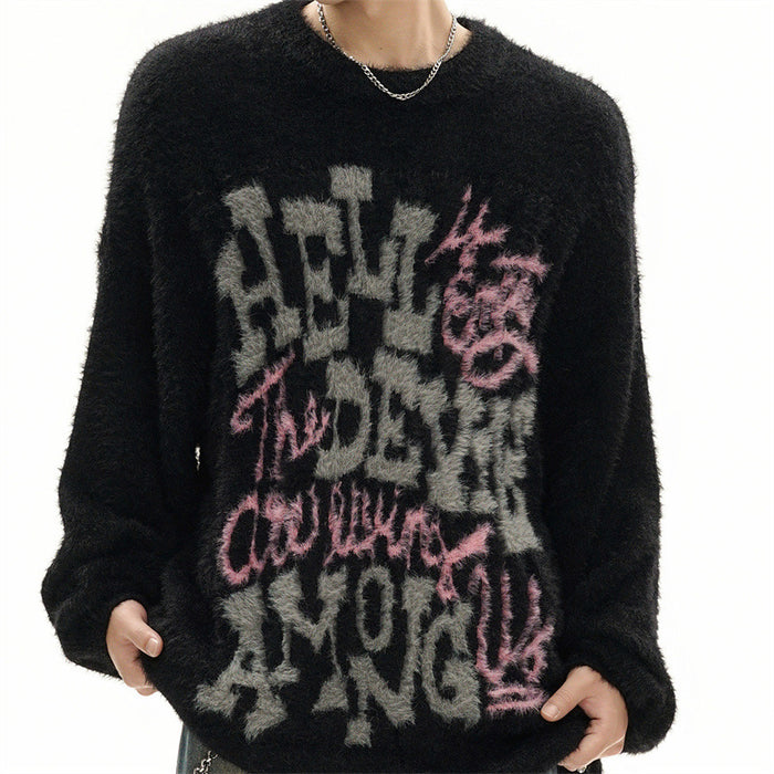 Black fuzzy knit sweater worn from the front with large gray and pink graphic lettering