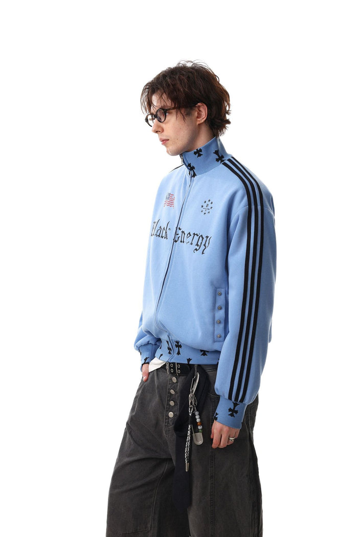 Side view of a model wearing the light blue track jacket with three black sleeve stripes