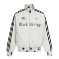 Front view of a light gray mock neck full-zip jacket with black stripes, flag graphic, and cross motifs