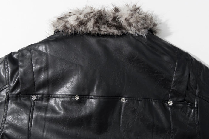 Close-up of the jacket's black faux leather back yoke with snap detailing and faux fur collar
