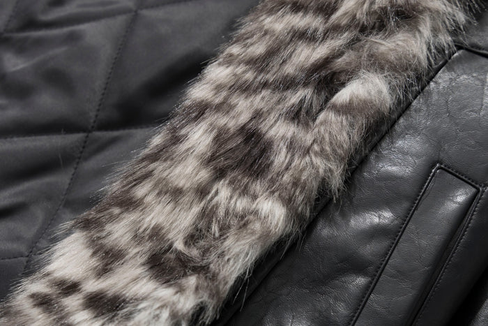 Close-up showing the jacket's gray-brown faux fur lining beside black quilted interior fabric