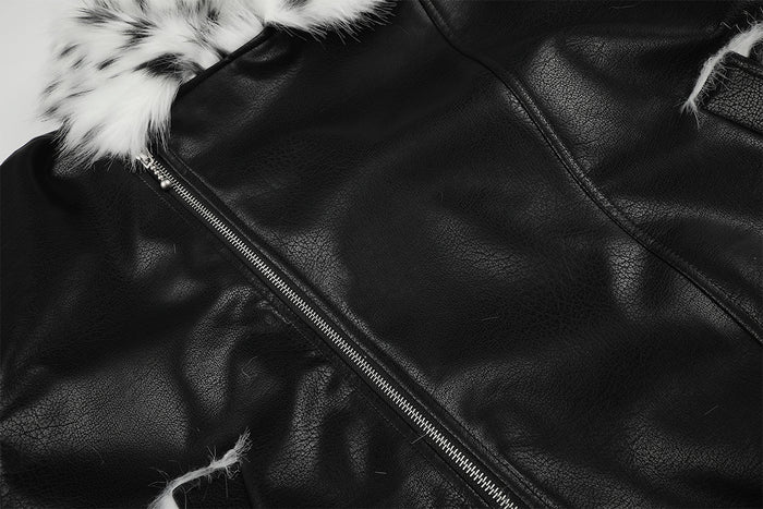 Close-up of the black faux leather jacket front showing the diagonal metal zipper and stitched panels