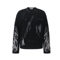 Black oversized long sleeve graphic tee with halftone portrait print, silver stud accents, and white script embroidery on sle
