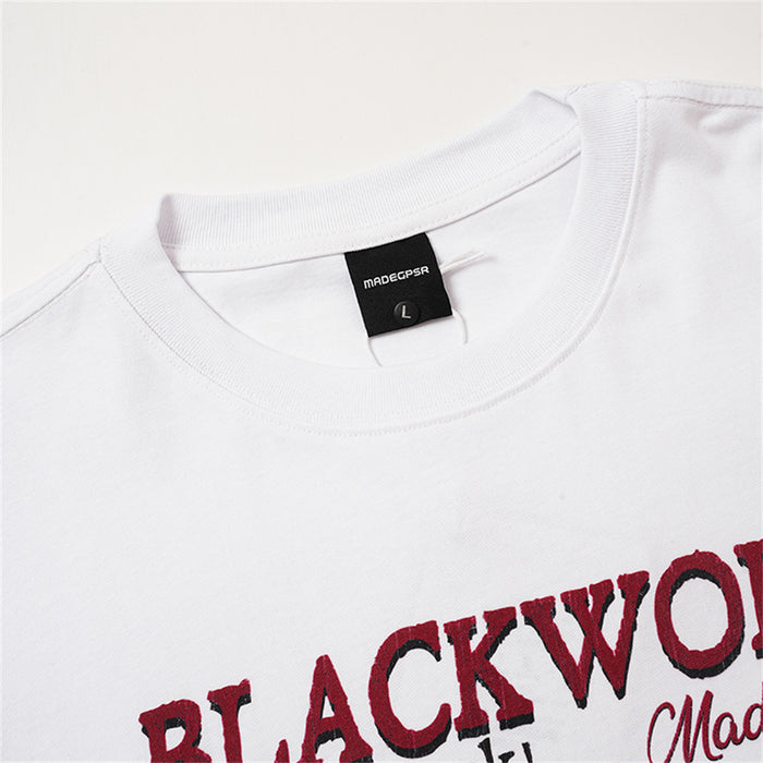 Close-up of the white T-shirt ribbed crew neck, size label, and upper graphic lettering