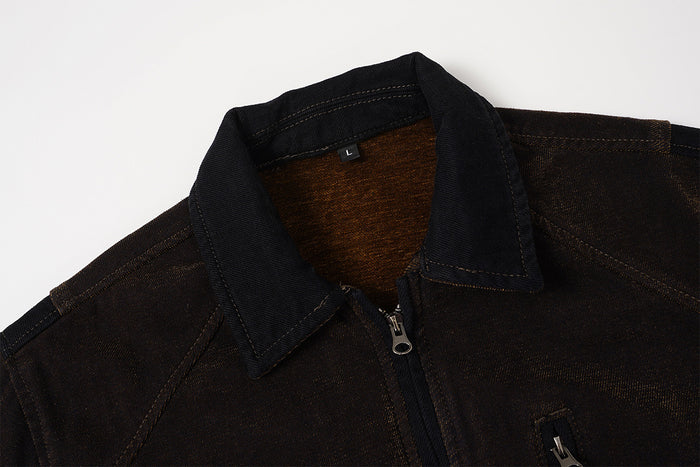 Close-up of the dark brown jacket collar, inner lining, stitching, and front zipper