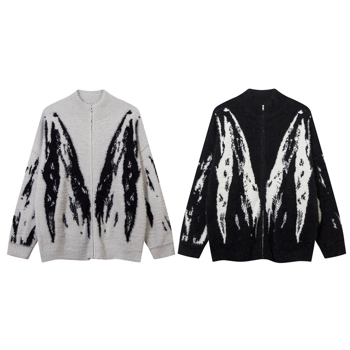 Two fuzzy zip-up knit cardigans in light gray and black with contrasting abstract white wing-like patterns