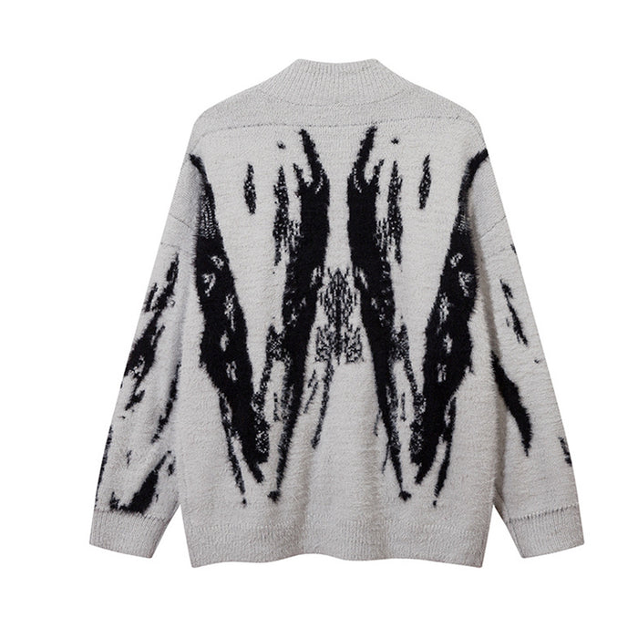 Back view of the light gray fuzzy knit cardigan with a large black abstract wing-like pattern