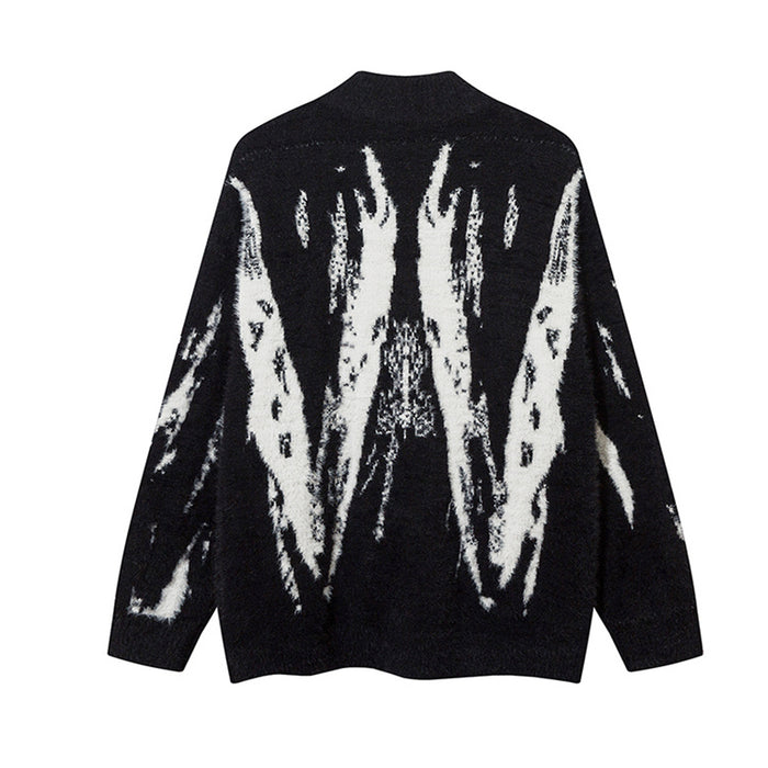 Back view of the black fuzzy knit cardigan featuring a large white abstract wing-like pattern