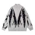 Light gray fuzzy knit cardigan shown from the front with a stand collar, zip closure, and black abstract pattern