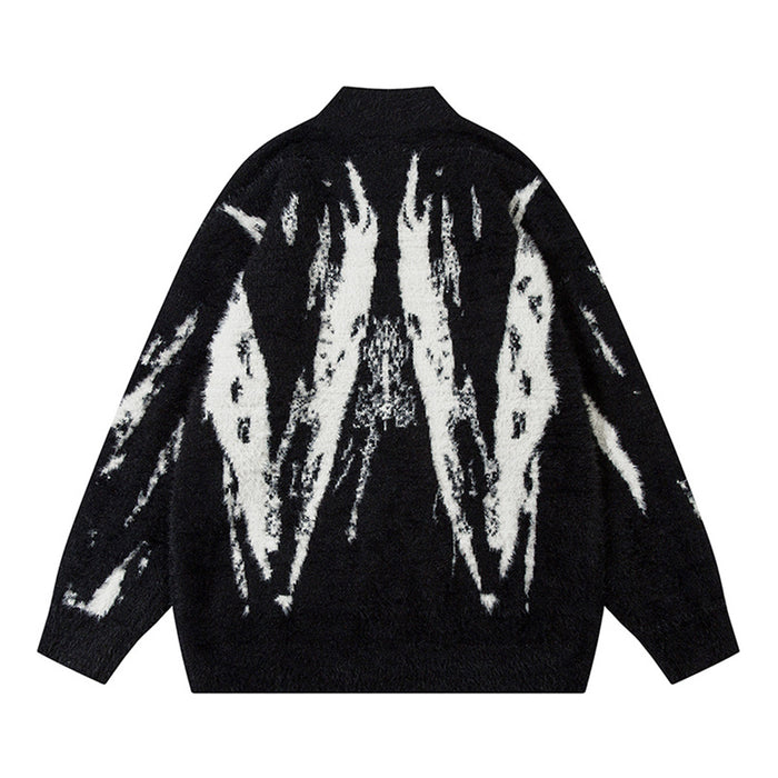 Back view of the black fuzzy knit cardigan with a large symmetrical white abstract pattern