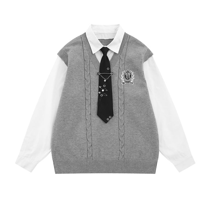 Gray cable-knit collegiate sweater vest with white shirt underlayer and black necktie with safety pin detail