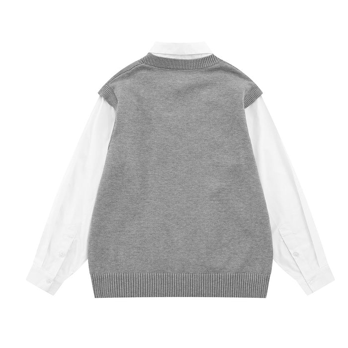 Back view of a gray cable-knit sweater vest layered over a white long-sleeve shirt