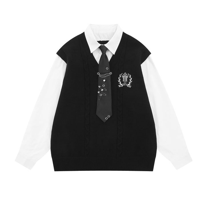 Front view of a black cable-knit sweater vest layered over a white shirt with a black tie and crest