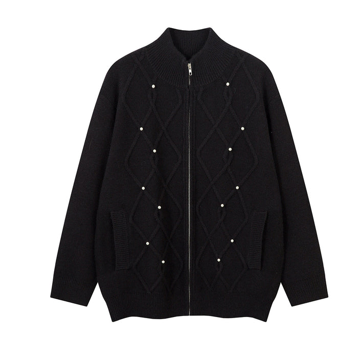 Black cable knit zip-up sweater jacket with pearl embellishments, front pockets, and a ribbed collar