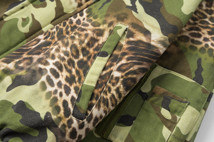 Close-up of a leopard-print zippered pocket panel set into the camouflage bomber jacket