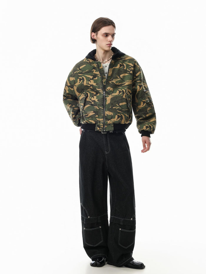 Model wearing the green and tan camouflage padded bomber jacket with black hood, cuffs, and ribbed hem