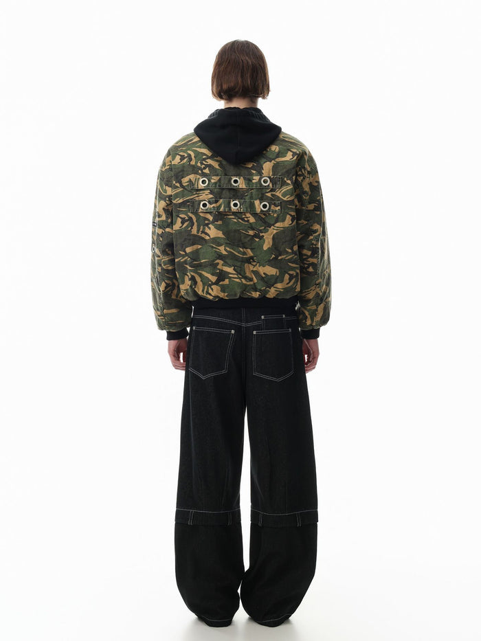 Back view of a model wearing the camouflage bomber jacket with black hood and two rows of metal grommets