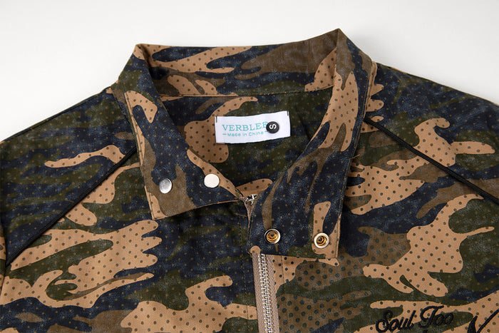 Inside collar detail showing a sewn label, snap closures, silver zipper, and camouflage pattern