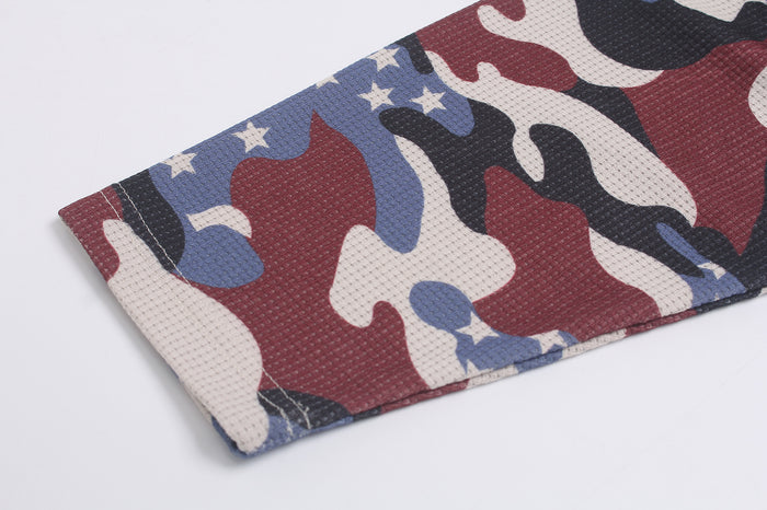 Close-up of a camouflage raglan sleeve hem with burgundy, blue, black, white, and gray pattern