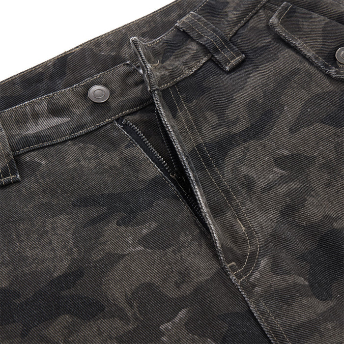 Close-up of the zip fly, button closure, belt loops, and camouflage denim-like fabric