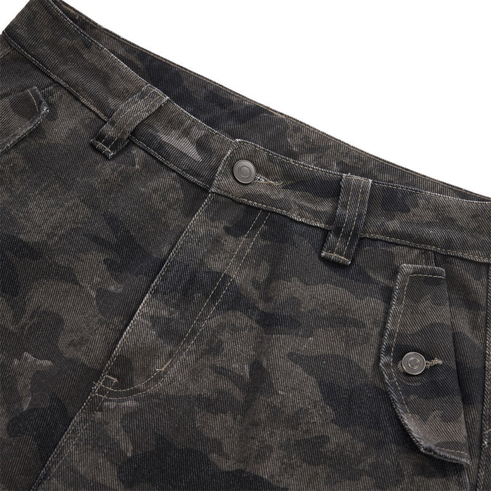 Front waistband detail showing belt loops, button closure, angled pocket, and camouflage texture
