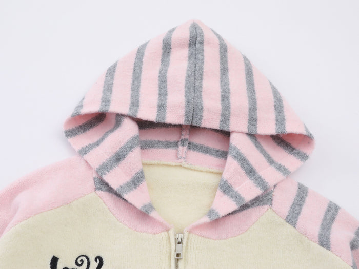 Close-up of the cream-pink hoodie hood with vertical gray stripes, striped inner edges, and a visible metal zipper