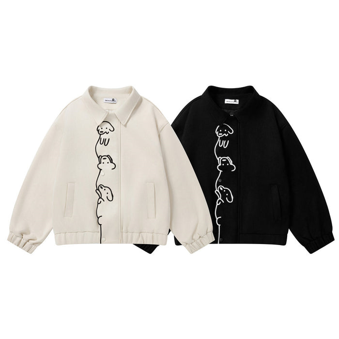 Cream and black varsity jackets shown from the front with stacked cartoon dog graphics and snap-button closures