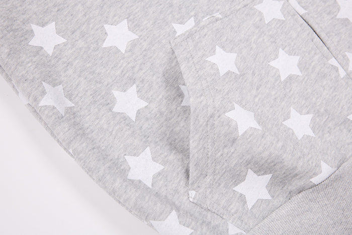 Close-up of the gray hoodie’s star-print front and curved kangaroo pocket seam