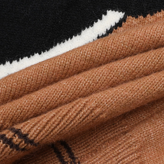 Close-up of brown knit fabric with ribbed folds and black-and-white graphic detailing