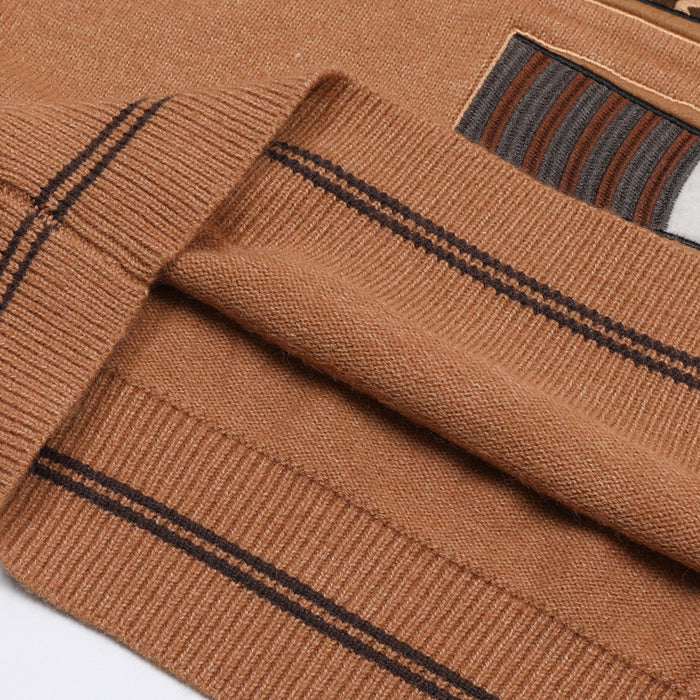 Close-up of the brown ribbed vest hem with dark stripe detailing and part of a graphic patch