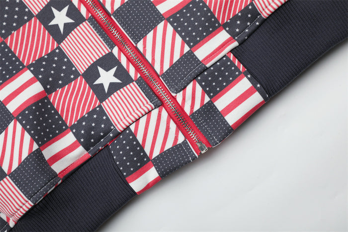 Close-up of the red zipper, patterned front panels, and dark ribbed waistband on the jacket