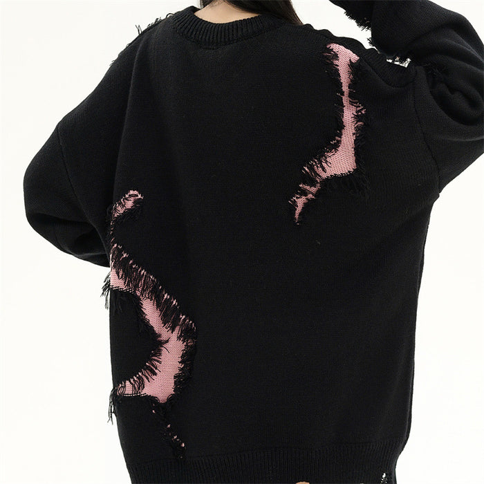 Back view of a black knit sweater featuring large pink distressed patches and a ribbed lower hem