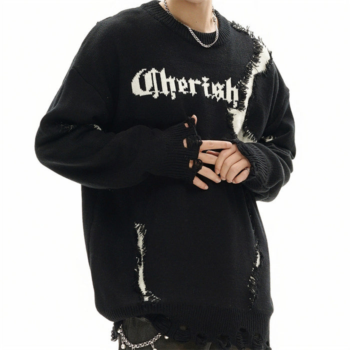 Angled model view of a black knit sweater with white distressed patches, oversized sleeves and ribbed cuffs