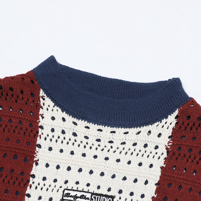 Close-up of the navy ribbed crew neckline and cream open-knit chest panel with burgundy side stripes