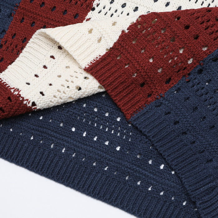 Close-up of the sweater’s ribbed hem and sleeve sections in navy, burgundy, and cream open-knit texture