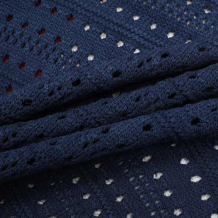 Close-up of the navy open-knit fabric showing textured stitches and evenly spaced perforations