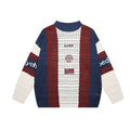 Front view of a navy, burgundy, and cream colorblock open-knit crew neck sweater with striped sleeves