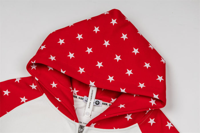 Close-up of the red star-print hood, showing the patterned outer fabric, lining, and sewn label