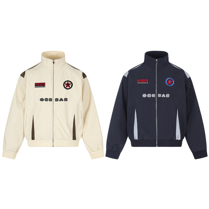 Front view of cream and navy stand-collar zip jackets with contrasting panels, patches, and chest lettering