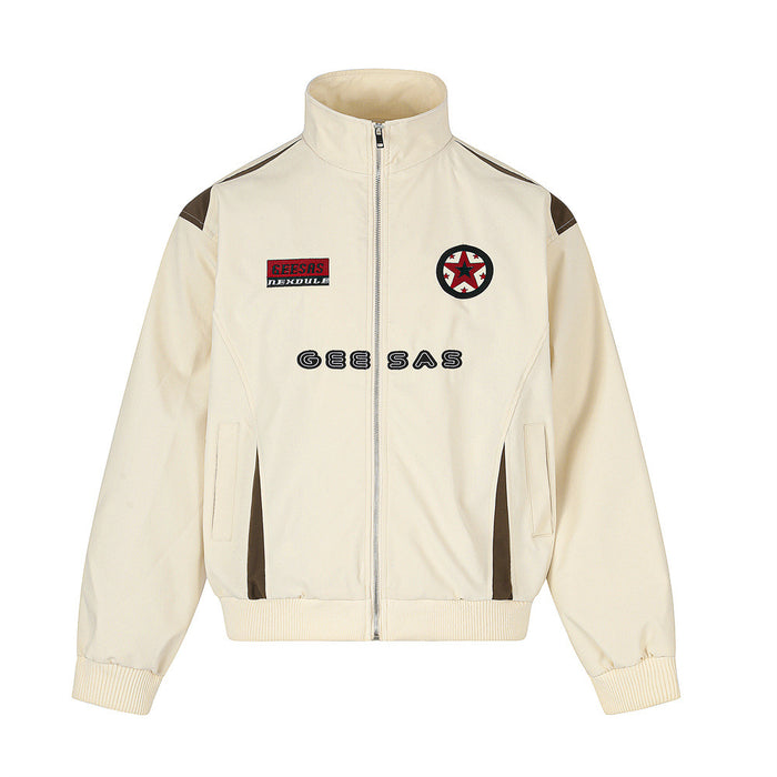 Cream stand-collar zip jacket shown from the front with brown contrast panels, patches, and chest lettering