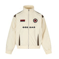 Cream stand-collar zip jacket shown from the front with brown contrast panels, patches, and chest lettering
