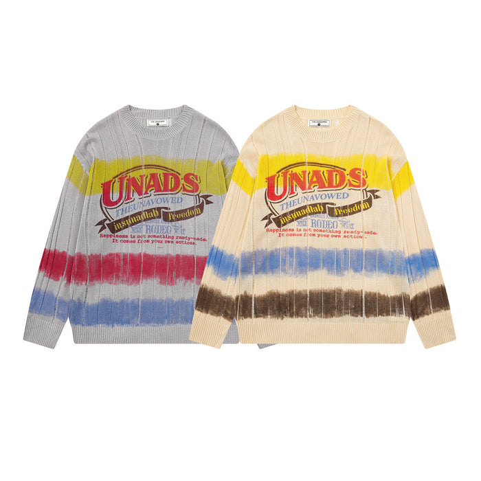 Two ribbed knit crew-neck sweaters in gray and cream with colorful horizontal stripes and graphic prints