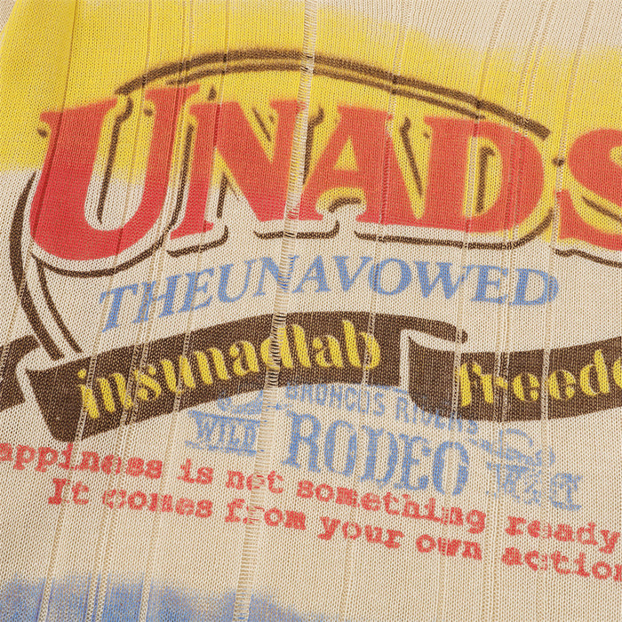 Close-up of the sweater graphic showing large red lettering with blue, yellow, and brown printed text